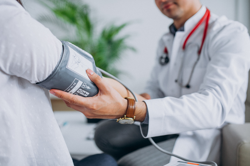 young-male-psysician-with-patient-measuring-blood-pressure